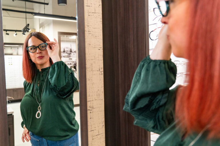 Client trying on frames during eyewear styling consultation at Sweet View Optical Studio