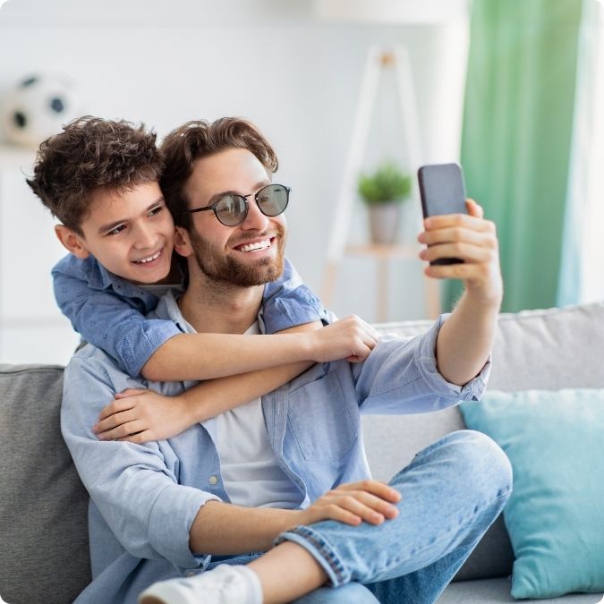 Father taking selfie with son while wearing Avulux glasses